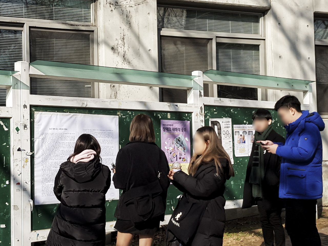 27일 오후 학생들이 새천년관 앞 게시판에 붙은 피해생존자 지지모임의 대자보를 읽고 있다.